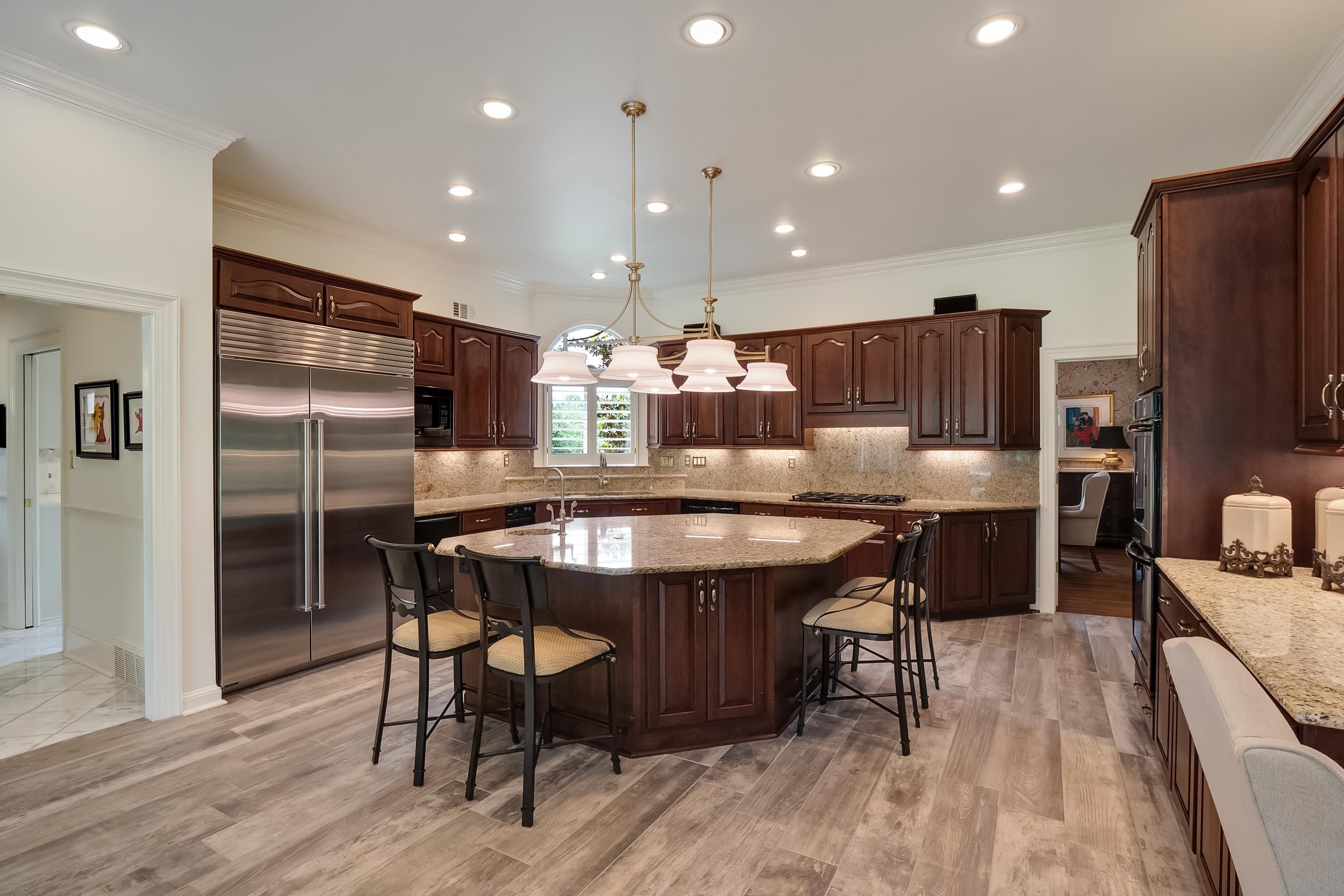 3044 Shea Road Collierville, TN 38017 - Photo 11 of 40 a kitchen with stainless steel appliances kitchen island granite countertop a table chairs stove and refrigerator