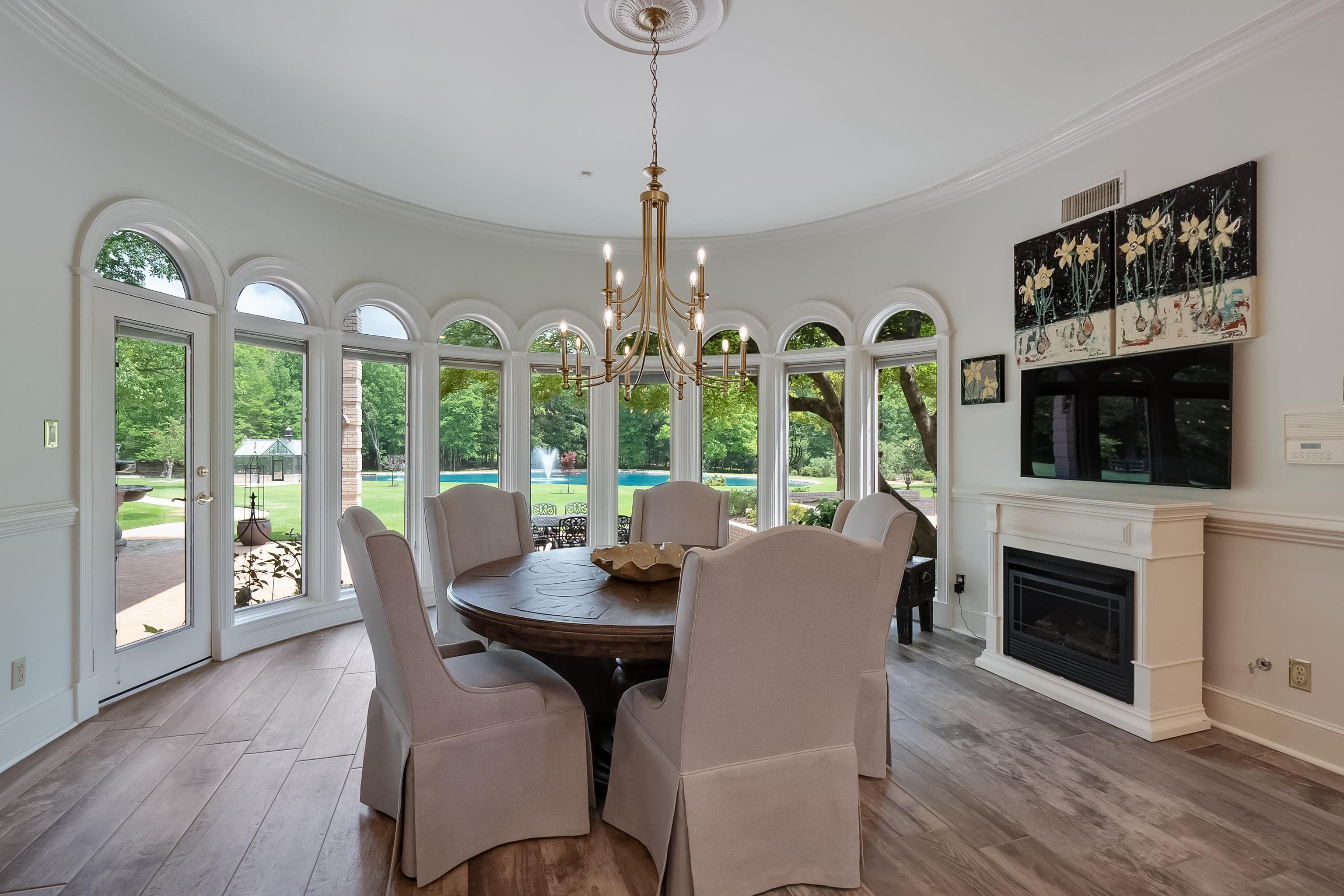 3044 Shea Road Collierville, TN 38017 - Photo 13 of 40 a dining room with furniture a chandelier and fireplace