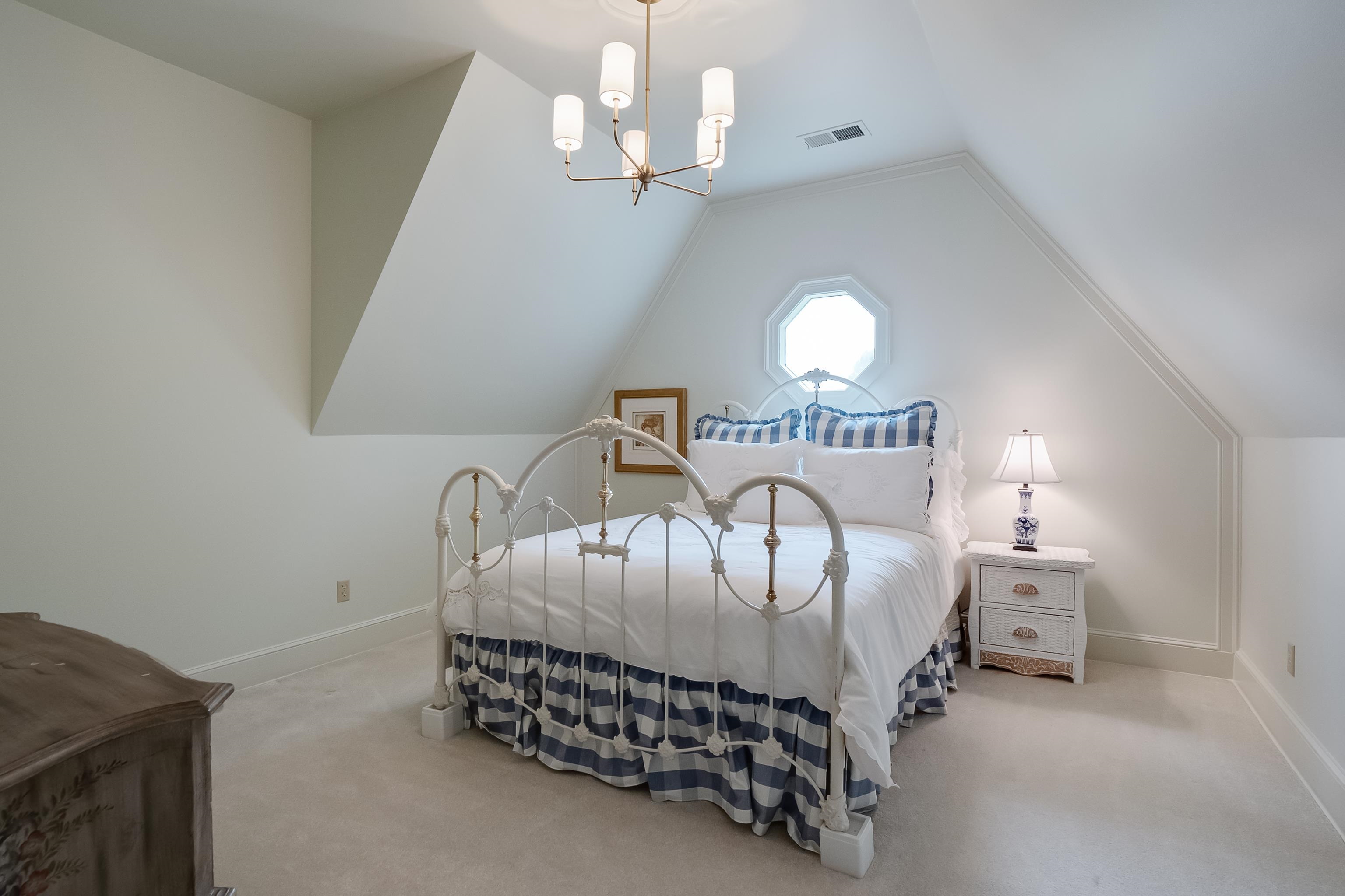 3044 Shea Road Collierville, TN 38017 - Photo 22 of 40 a bedroom with a bed and a chandelier