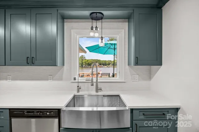 a kitchen with a sink and a large window