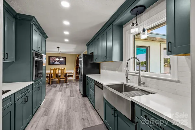 a kitchen with sink cabinets and wooden floor