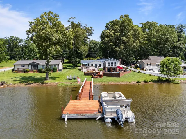 a view of a lake with house swimming pool and outdoor space