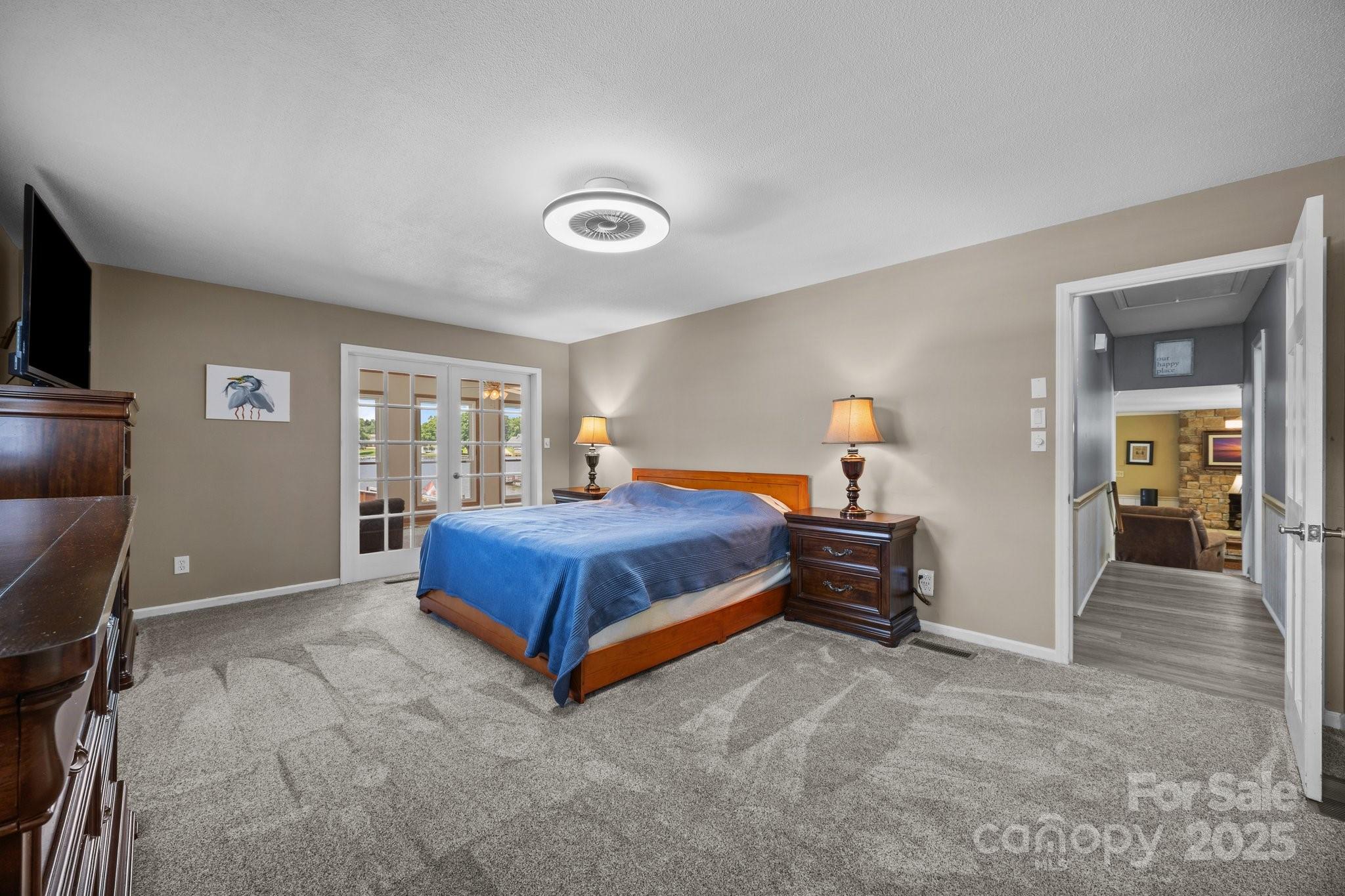 1017 Holloway Church Road Lexington, NC 27292 - Photo 22 of 48 a bedroom with a bed and a flat tv screen on dresser