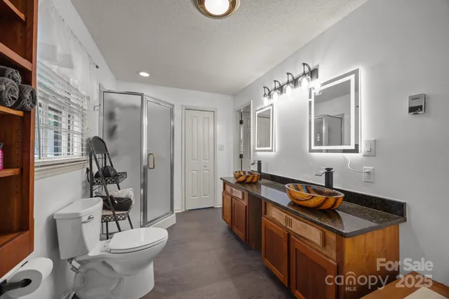 a spacious bathroom with a toilet sink and mirror