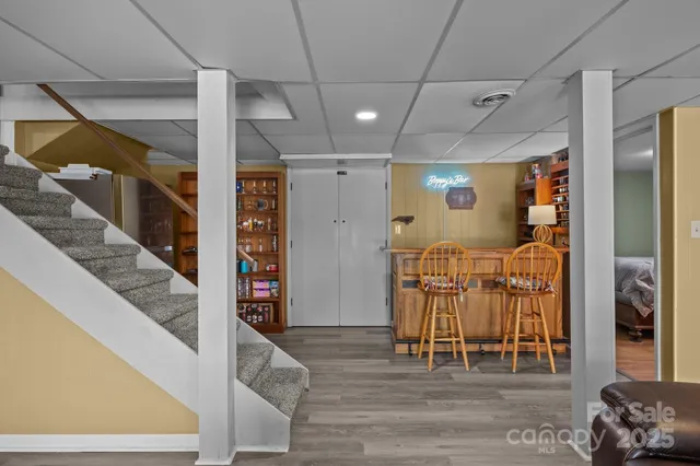 a living room with furniture a flat screen tv and a floor to ceiling window