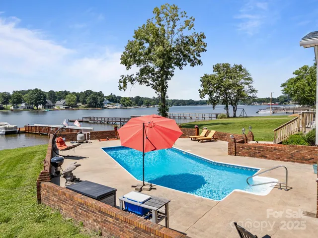 a view of a swimming pool with lounge chairs
