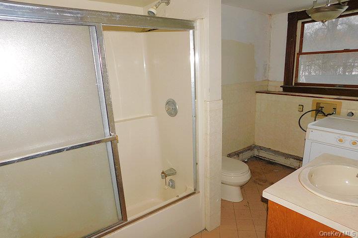 853 Salt Point Turnpike Poughkeepsie, NY 12601 - Photo 11 of 25 a bathroom with a sink a toilet and shower