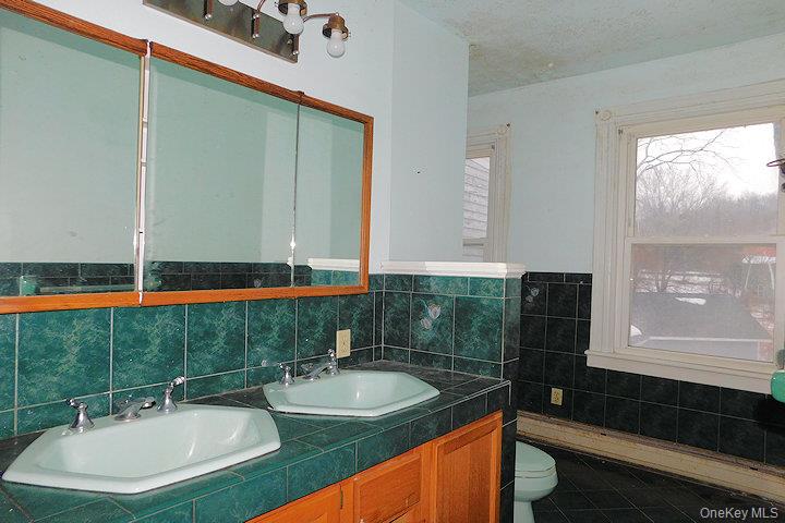 853 Salt Point Turnpike Poughkeepsie, NY 12601 - Photo 13 of 25 a bathroom with a sink and a mirror
