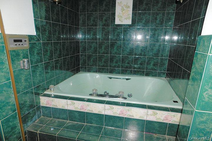 853 Salt Point Turnpike Poughkeepsie, NY 12601 - Photo 14 of 25 a bathroom with a bathtub and a shower