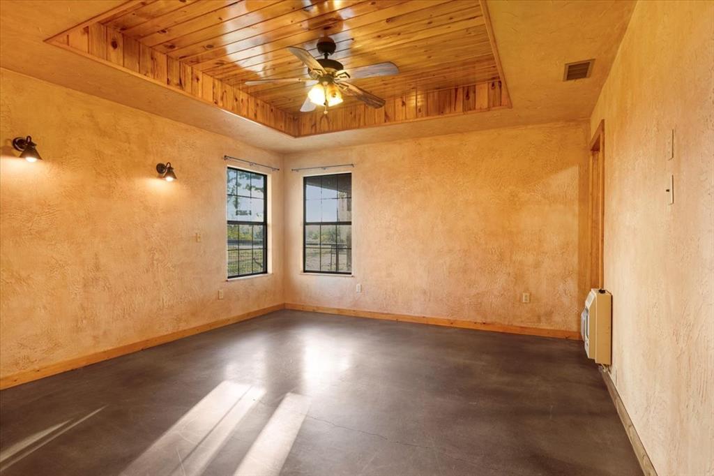 1809 County Road Winnsboro, TX 75494 - Photo 14 of 39 an empty room with wooden floor and windows