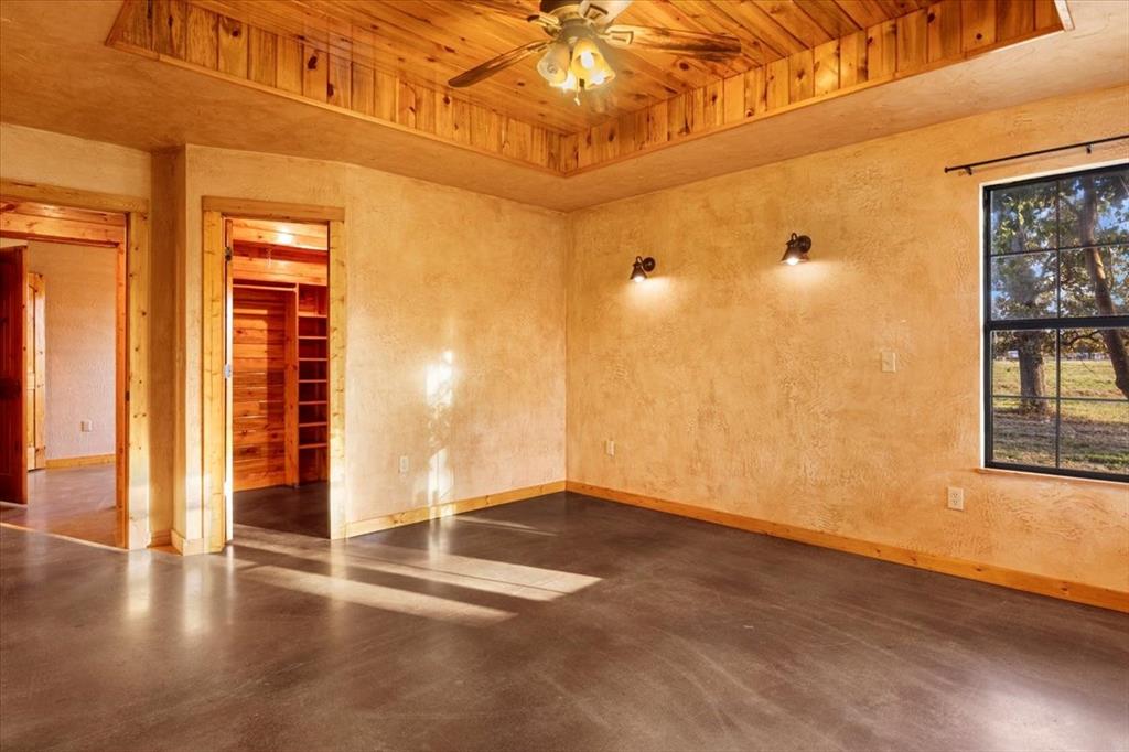 1809 County Road Winnsboro, TX 75494 - Photo 15 of 39 a view of an empty room with window and wooden floor