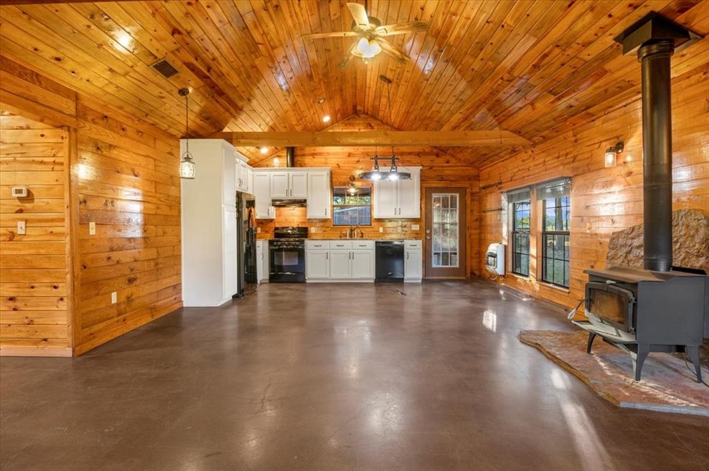 1809 County Road Winnsboro, TX 75494 - Photo 5 of 39 a view of a livingroom with furniture hardwood floor and a kitchen