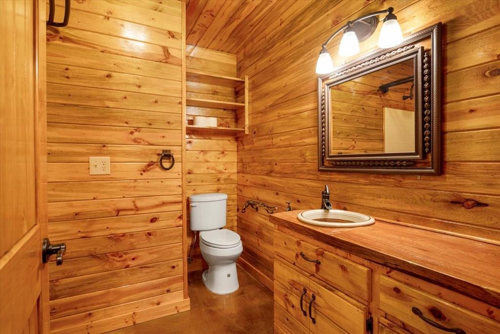 1809 County Road Winnsboro, TX 75494 - Photo 9 of 39 a bathroom with a granite countertop toilet and sink