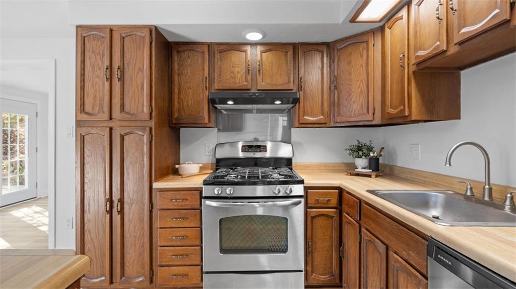 161 Warrencliff Drive Monaca, PA 15061 - Photo 25 of 40 a kitchen with stainless steel appliances granite countertop a stove and a sink