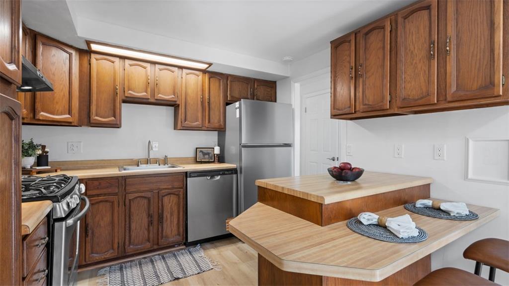 161 Warrencliff Drive Monaca, PA 15061 - Photo 26 of 40 a kitchen with stainless steel appliances granite countertop a sink dishwasher stove refrigerator and cabinets