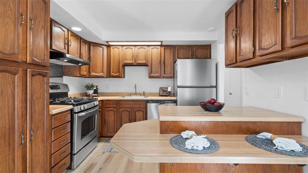 161 Warrencliff Drive Monaca, PA 15061 - Photo 27 of 40 a kitchen with stainless steel appliances granite countertop a sink stove and refrigerator
