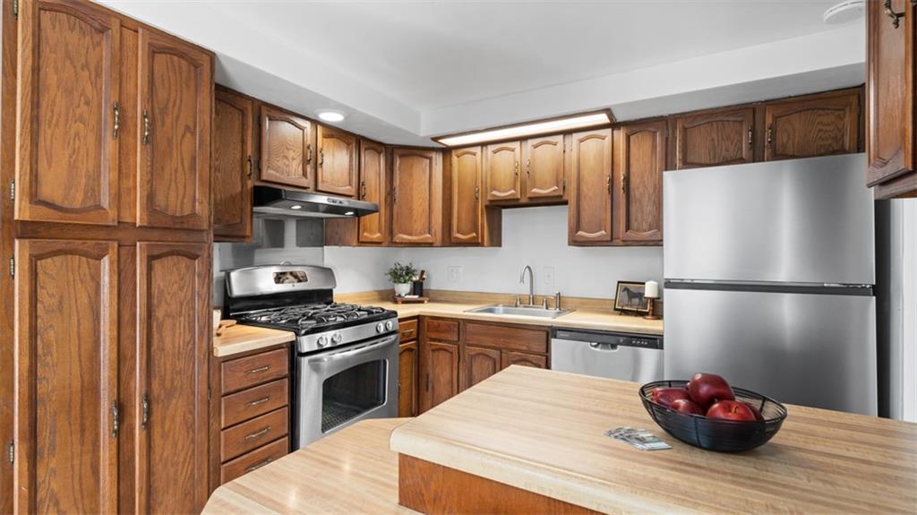 161 Warrencliff Drive Monaca, PA 15061 - Photo 28 of 40 a kitchen with stainless steel appliances granite countertop a refrigerator sink stove and cabinets