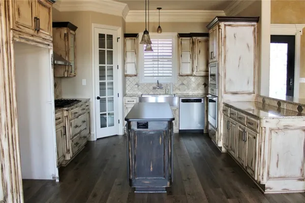 a view of a room with wooden floor and door