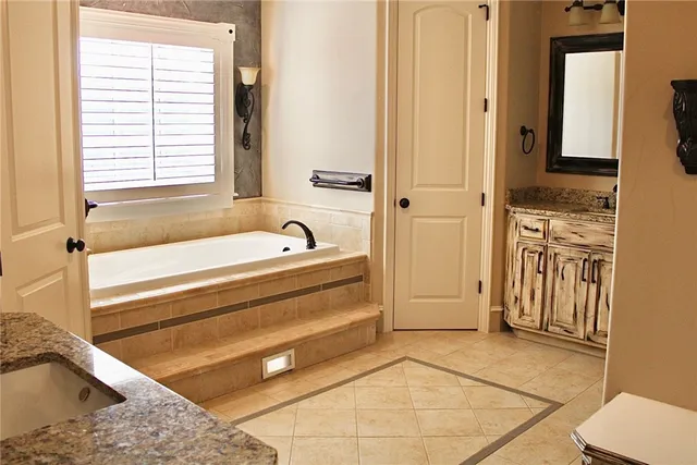 a bathroom with a sink vanity and a mirror