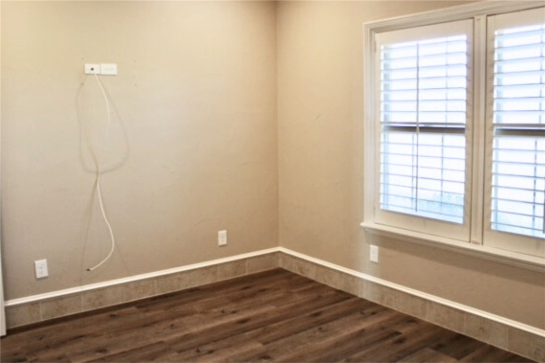100 Deer Creek Drive Waco, TX 76708 - Photo 24 of 26 a view of an empty room with wooden floor and a window