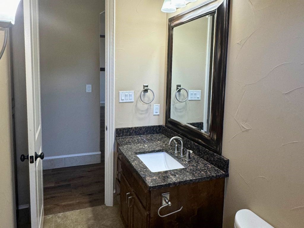 100 Deer Creek Drive Waco, TX 76708 - Photo 26 of 26 a bathroom with a granite countertop sink and a mirror