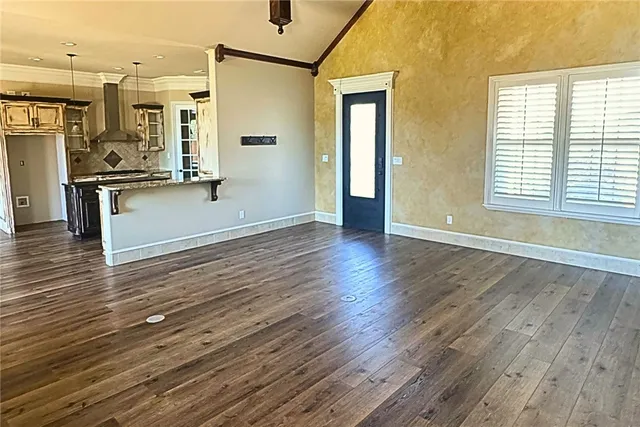 a living room with a fireplace and wooden floor