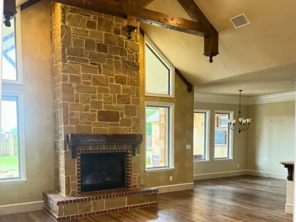 a view of a room with wooden floor