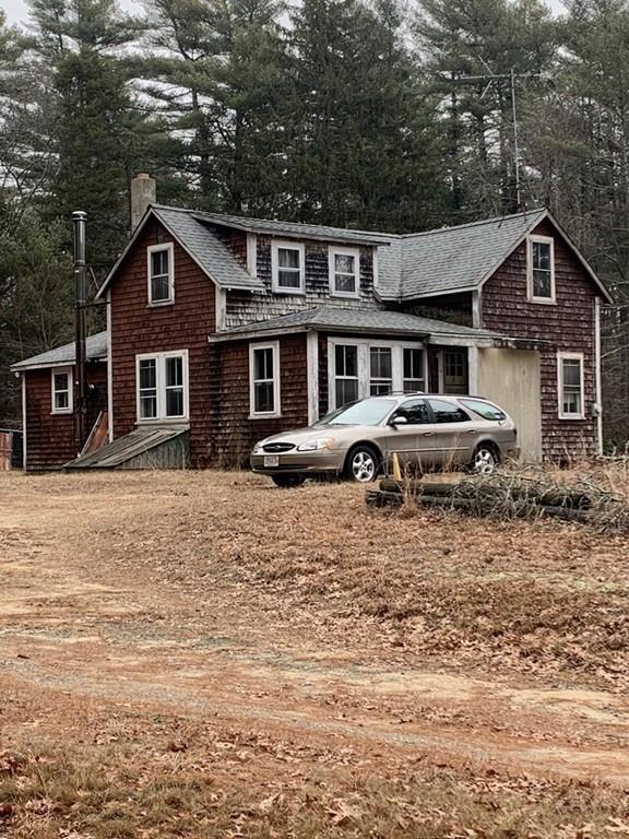 19 Cross Road Wareham, MA 02576 - Photo 3 of 4 a front view of a house with yard and trees in the background