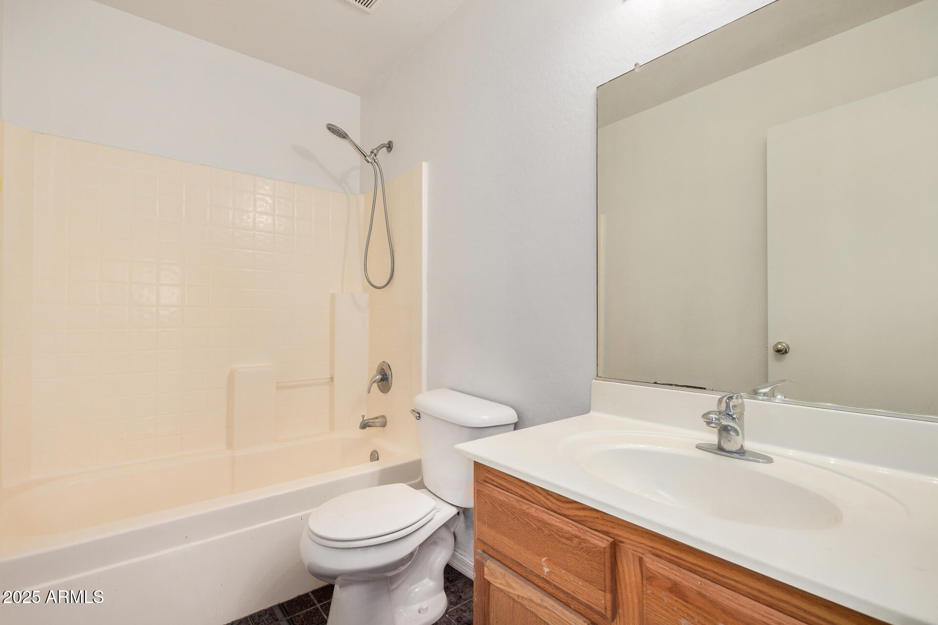 44014 West Magnolia Road Maricopa, AZ 85138 - Photo 11 of 18 a bathroom with a sink a toilet and a large mirror