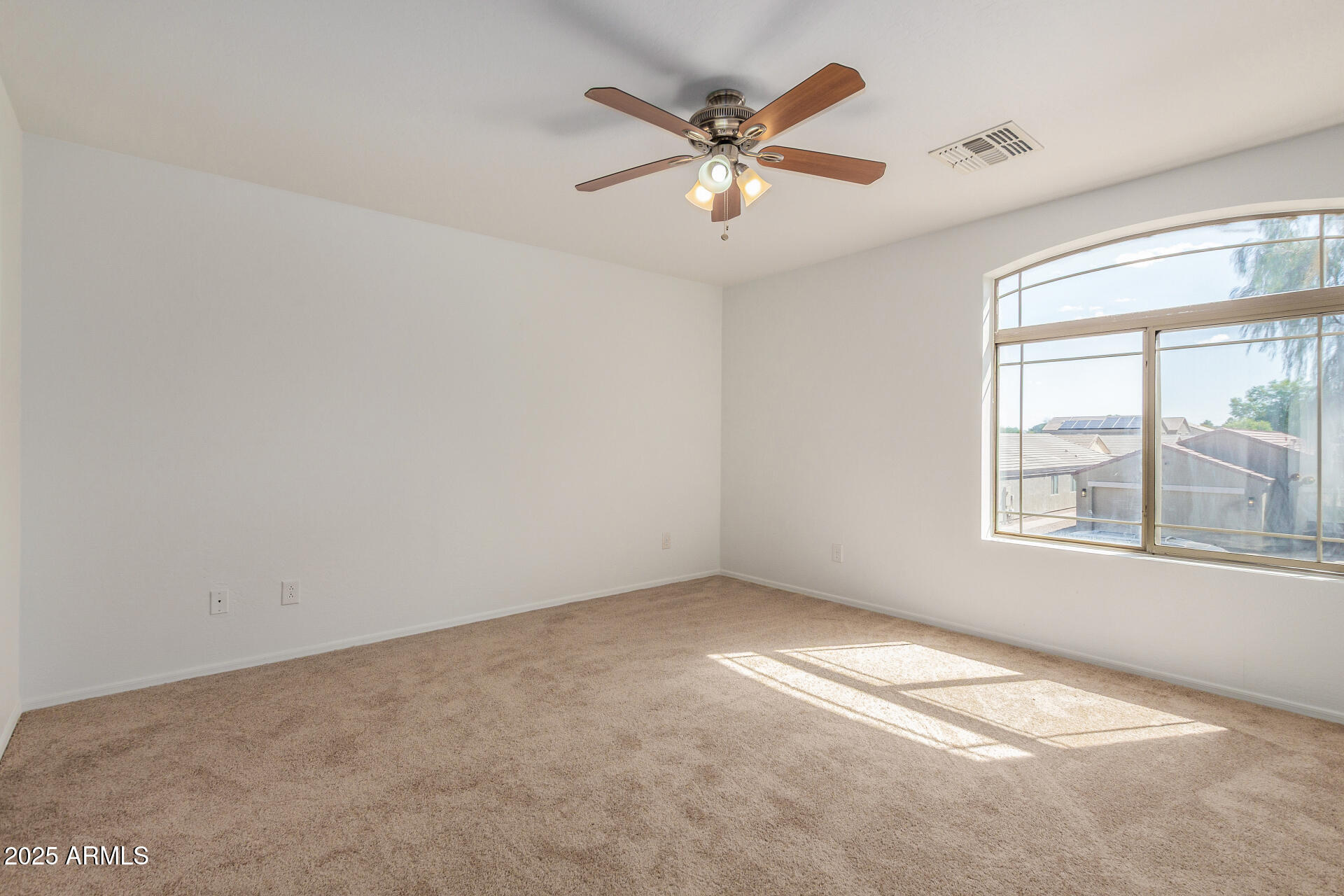 44014 West Magnolia Road Maricopa, AZ 85138 - Photo 13 of 18 an empty room with windows and fan