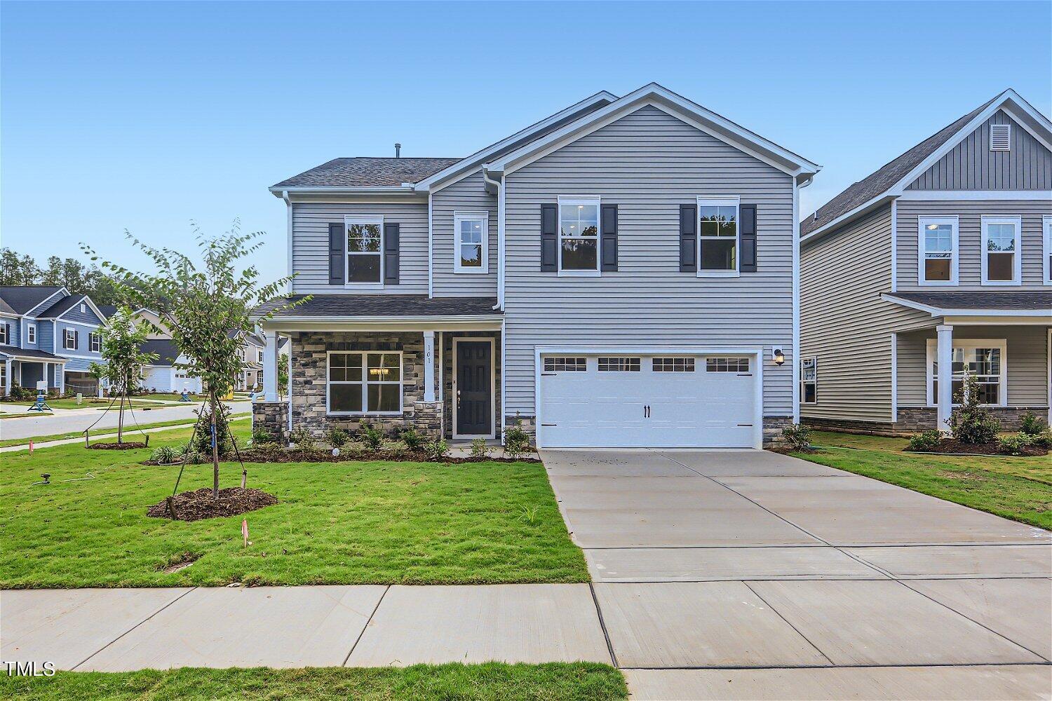 128 Eden View Bend, Unit 672 Raleigh, NC 27610 - Photo 1 of 16 a front view of a house with a yard and trees