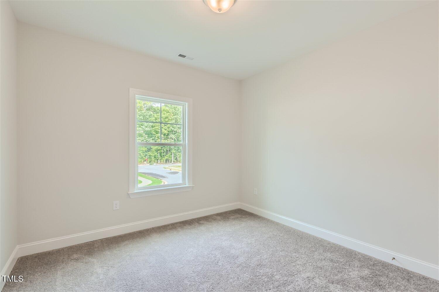 128 Eden View Bend, Unit 672 Raleigh, NC 27610 - Photo 12 of 16 an empty room with a window