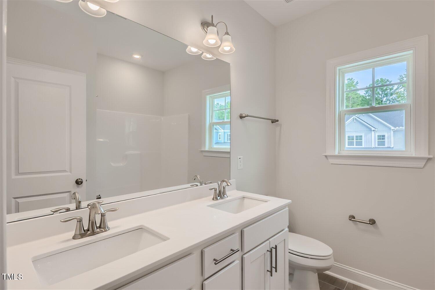 128 Eden View Bend, Unit 672 Raleigh, NC 27610 - Photo 13 of 16 a bathroom with a sink toilet and a mirror