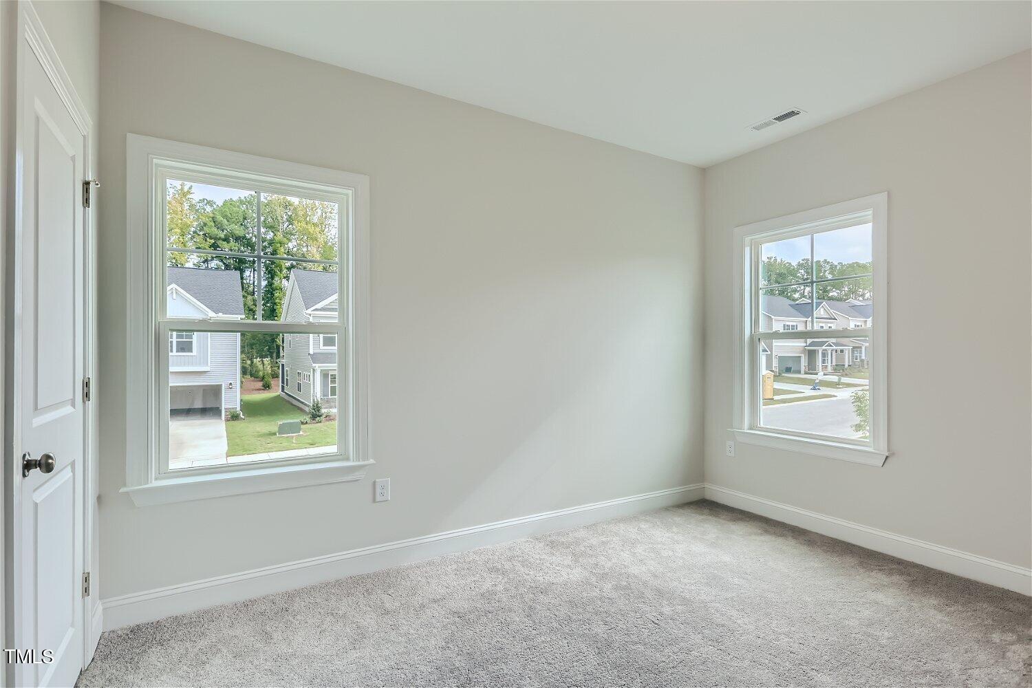 128 Eden View Bend, Unit 672 Raleigh, NC 27610 - Photo 14 of 16 an empty room with windows