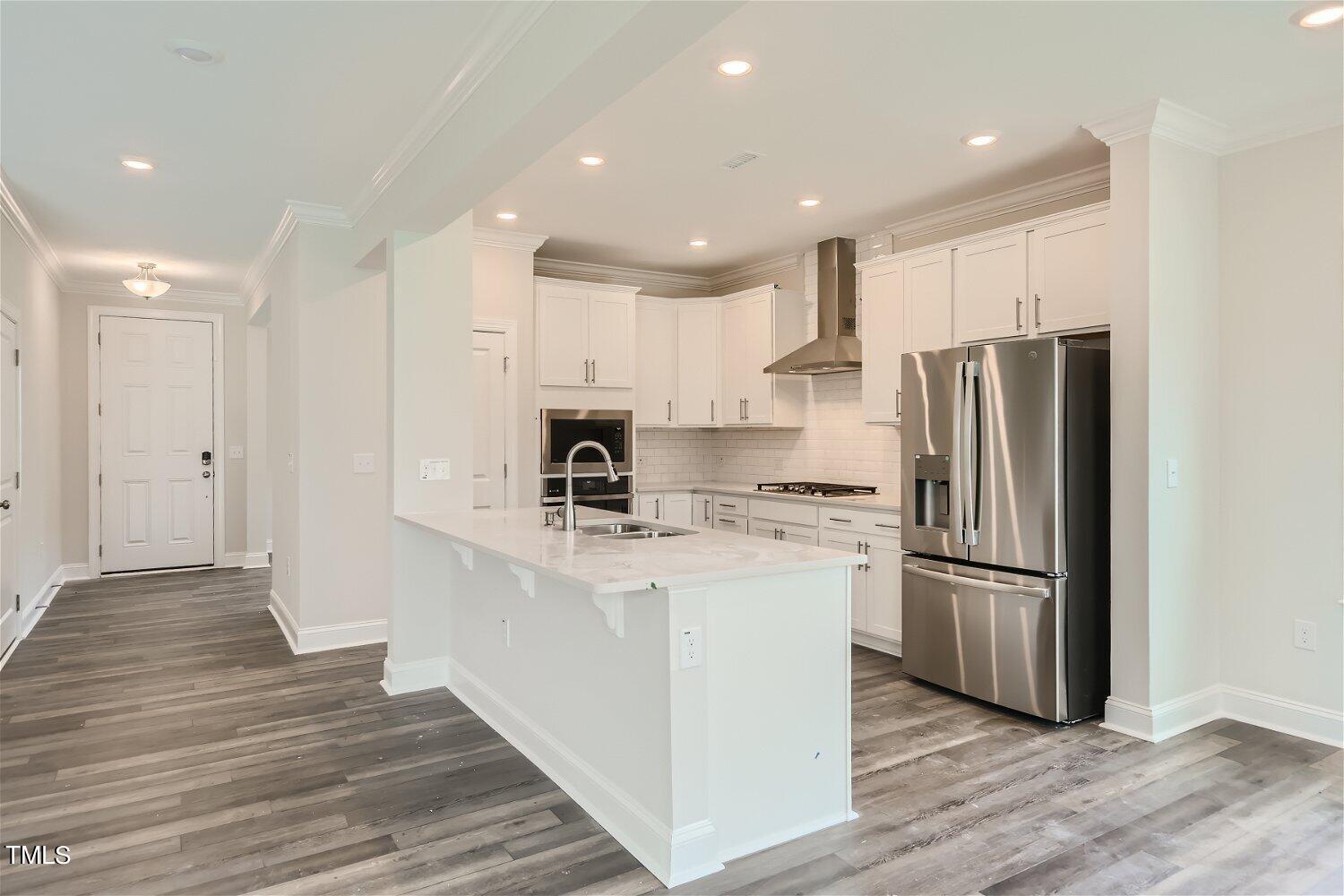 128 Eden View Bend, Unit 672 Raleigh, NC 27610 - Photo 3 of 16 a kitchen with stainless steel appliances a refrigerator sink and microwave