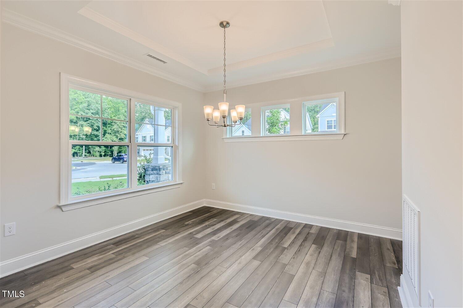 128 Eden View Bend, Unit 672 Raleigh, NC 27610 - Photo 5 of 16 a view of a room with wooden floor and windows