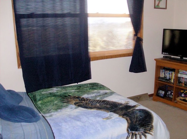 5351 South Mill Pond Road Rochelle, IL 61068 - Photo 11 of 17 a bedroom with a bed tv and a window