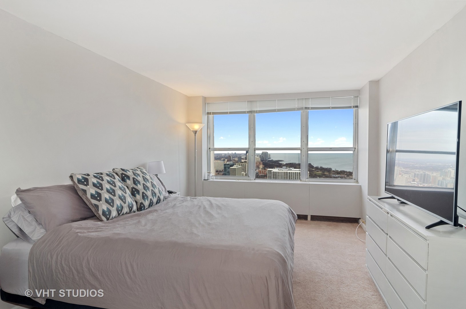 655 Irving Park Road, Unit 4606 Chicago, IL 60613 - Photo 4 of 15 a bedroom with a large bed and a large window