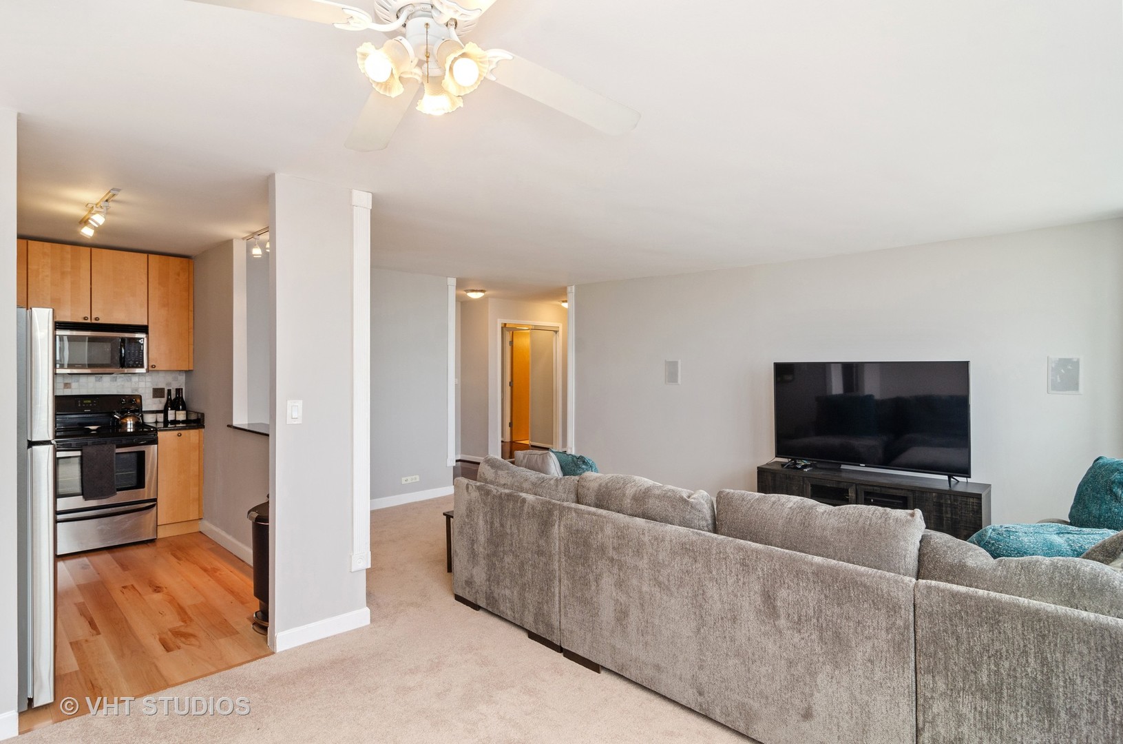 655 Irving Park Road, Unit 4606 Chicago, IL 60613 - Photo 6 of 15 a living room with furniture and a flat screen tv