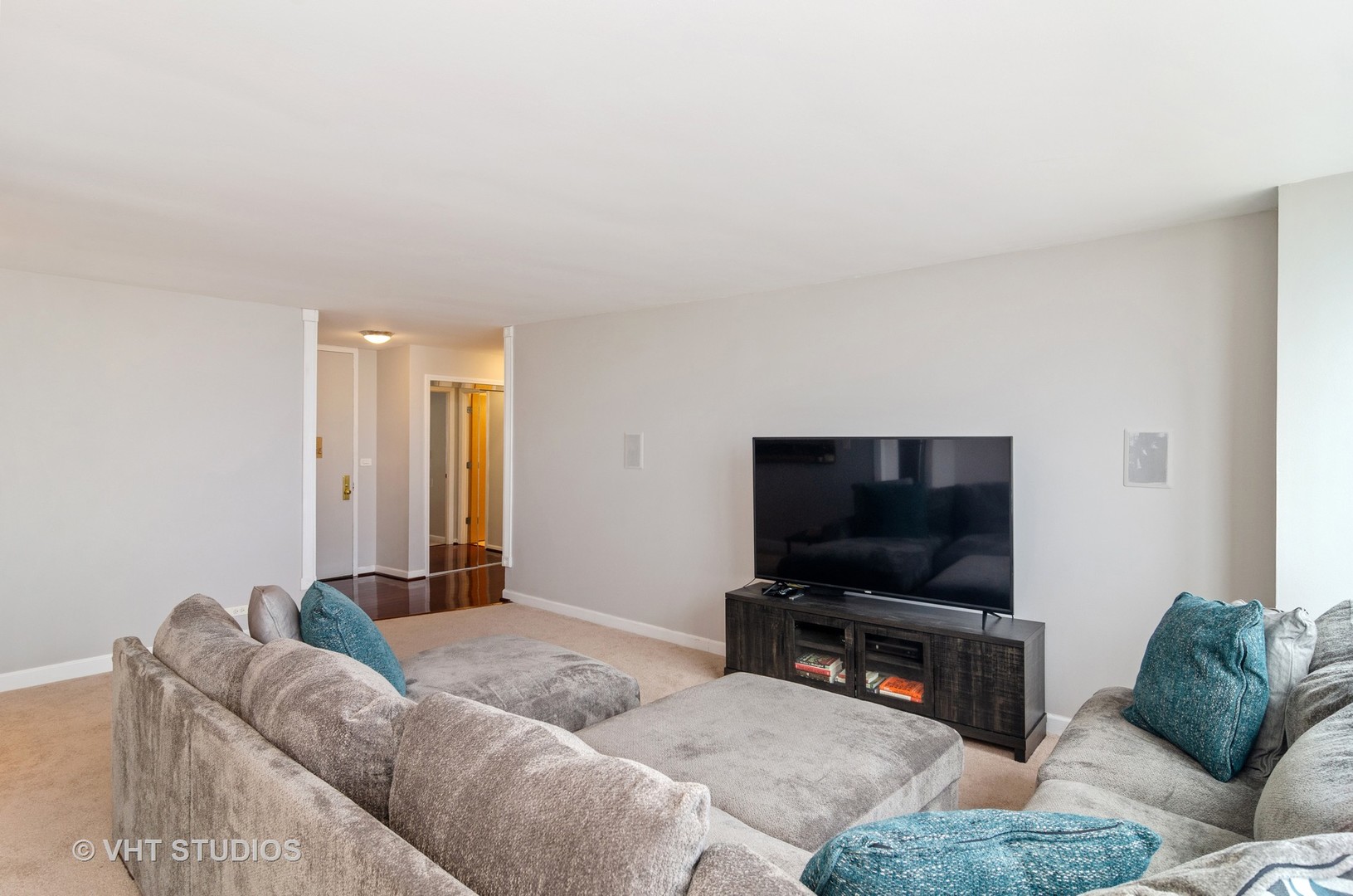 655 Irving Park Road, Unit 4606 Chicago, IL 60613 - Photo 8 of 15 a living room with furniture and a flat screen tv