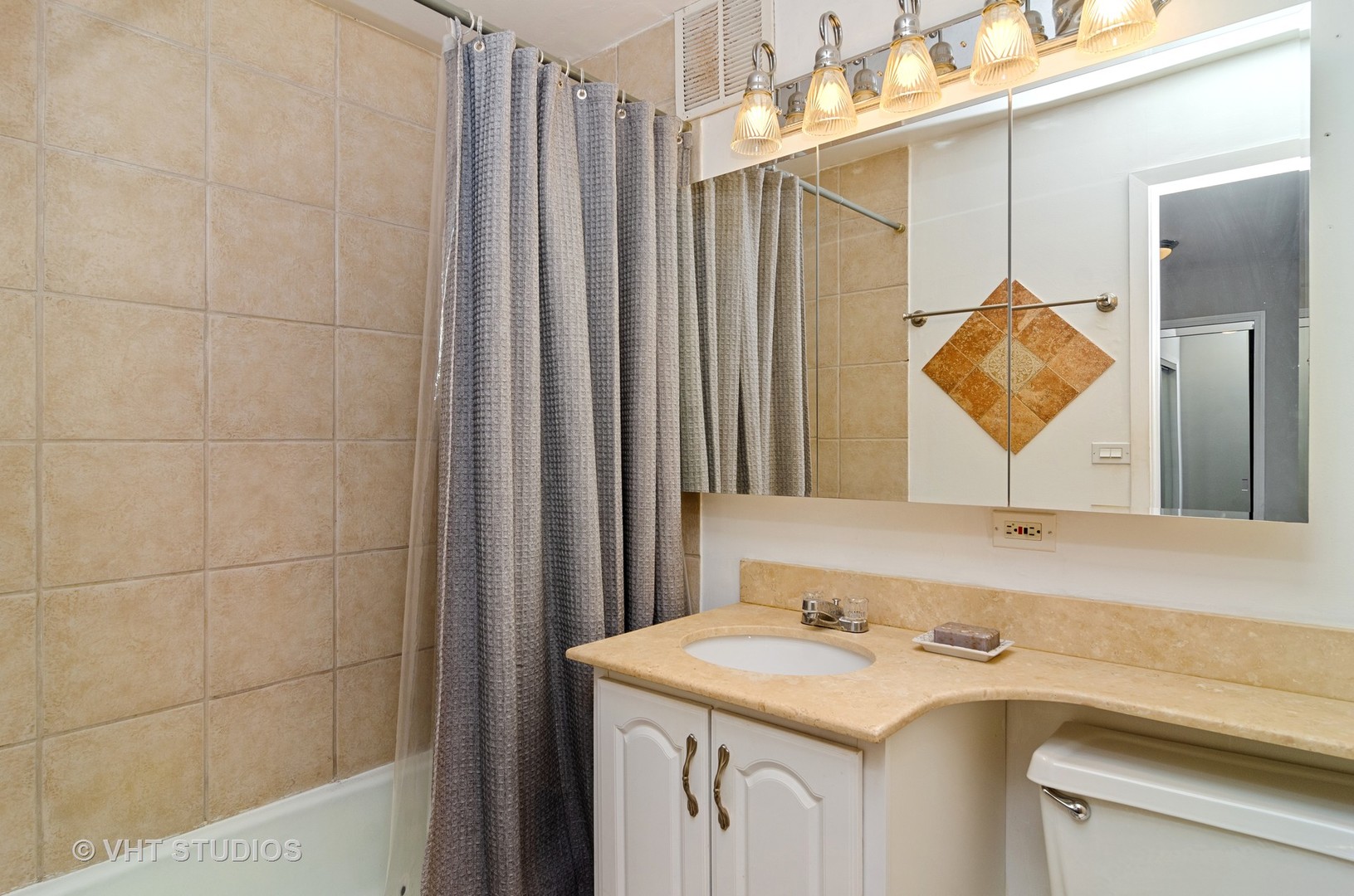 655 Irving Park Road, Unit 4606 Chicago, IL 60613 - Photo 9 of 15 a bathroom with a sink and a mirror