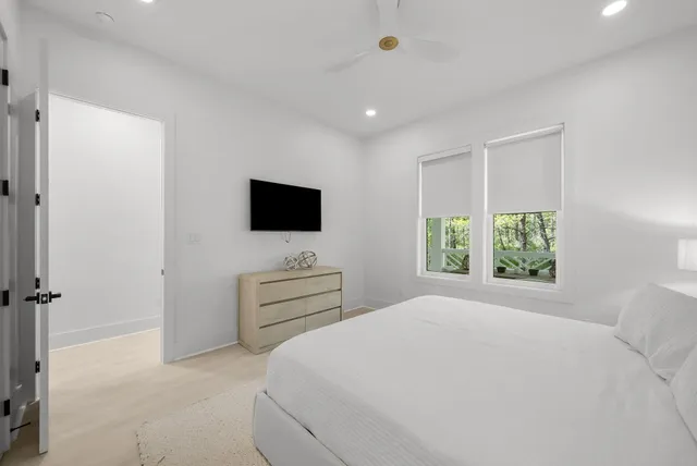 a bedroom with a flat screen tv on wall and a flat screen tv