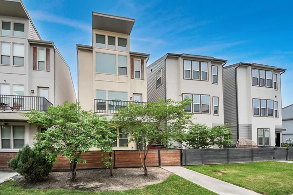 a front view of a house with a yard and a garage