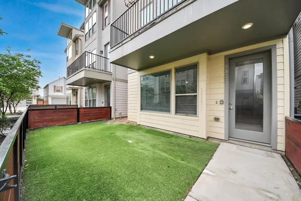 a swimming pool with outdoor seating and yard