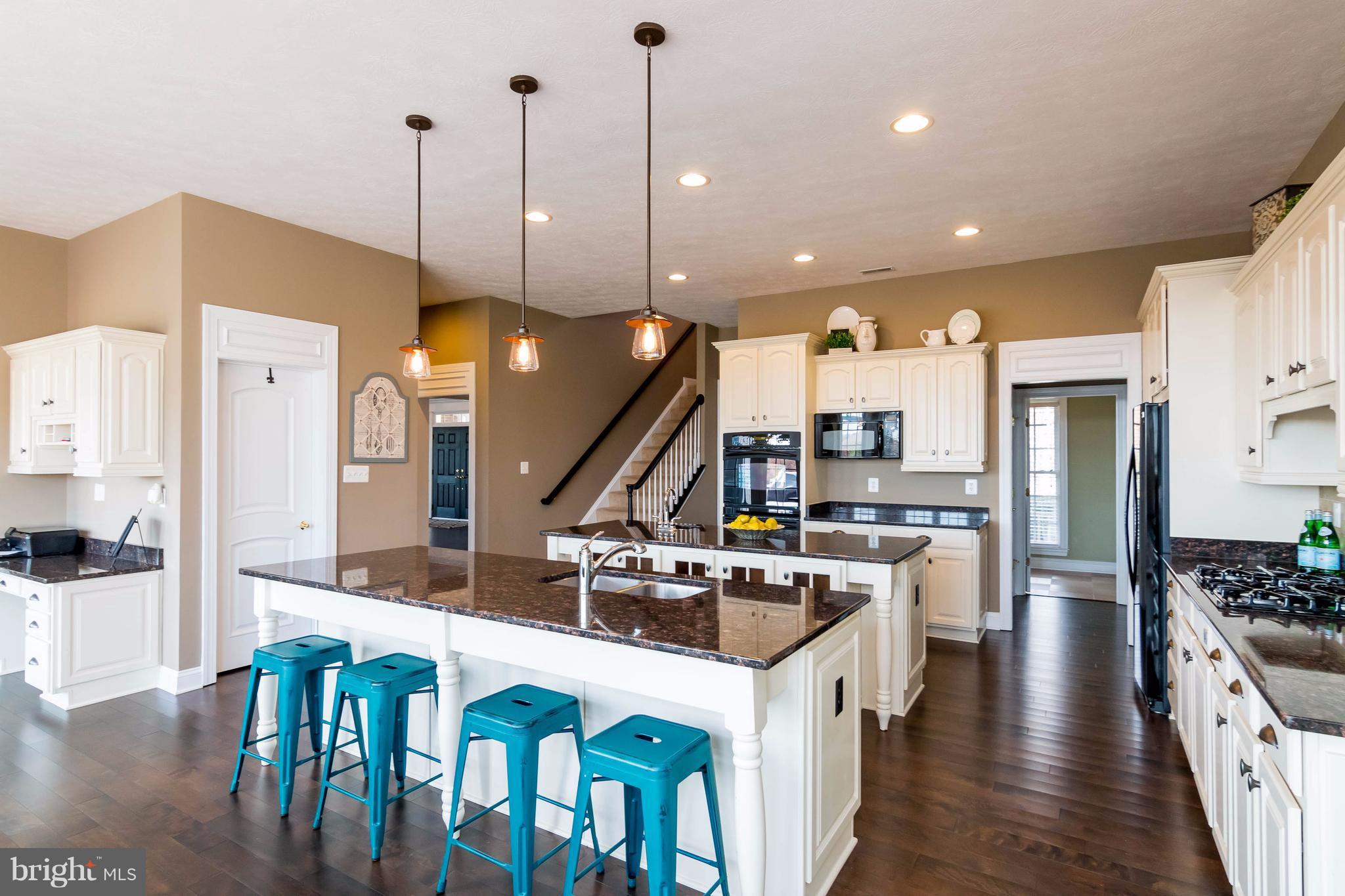 2404 Long Ridge Road Reisterstown, MD 21136 - Photo 14 of 30 a kitchen with a table chairs stove and wooden floor