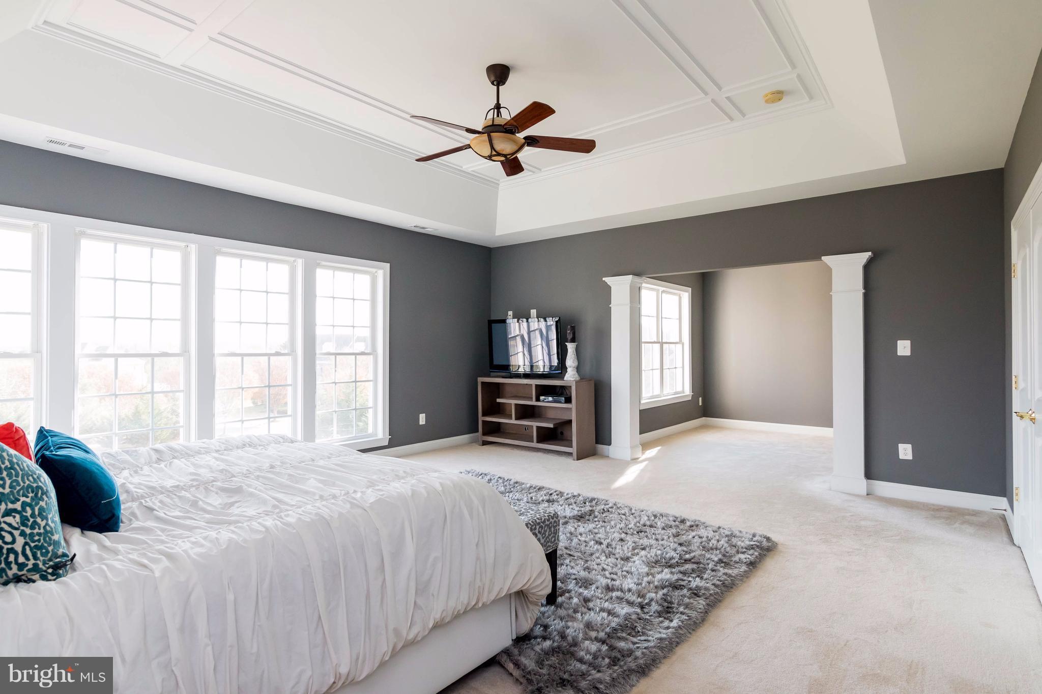 2404 Long Ridge Road Reisterstown, MD 21136 - Photo 16 of 30 a spacious bedroom with a large bed and a chandelier