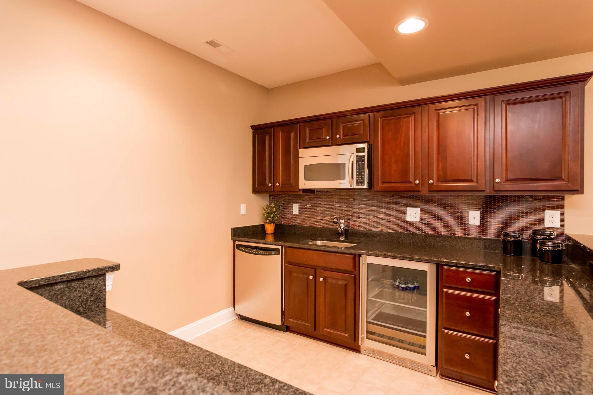2404 Long Ridge Road Reisterstown, MD 21136 - Photo 26 of 30 a kitchen with stainless steel appliances granite countertop a sink and cabinets