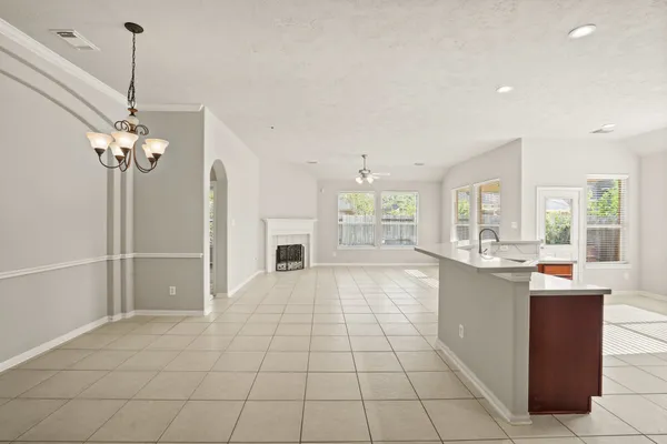 a large white kitchen with a large window
