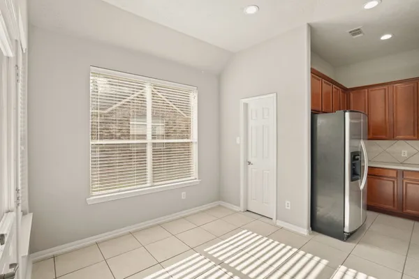 a view of an empty room with a kitchen
