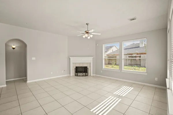 a view of an empty room with glass door and a window